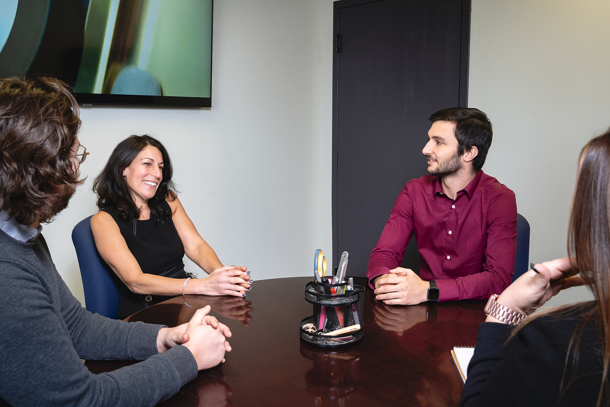 Colleagues sharing a candid conversation around a conference table